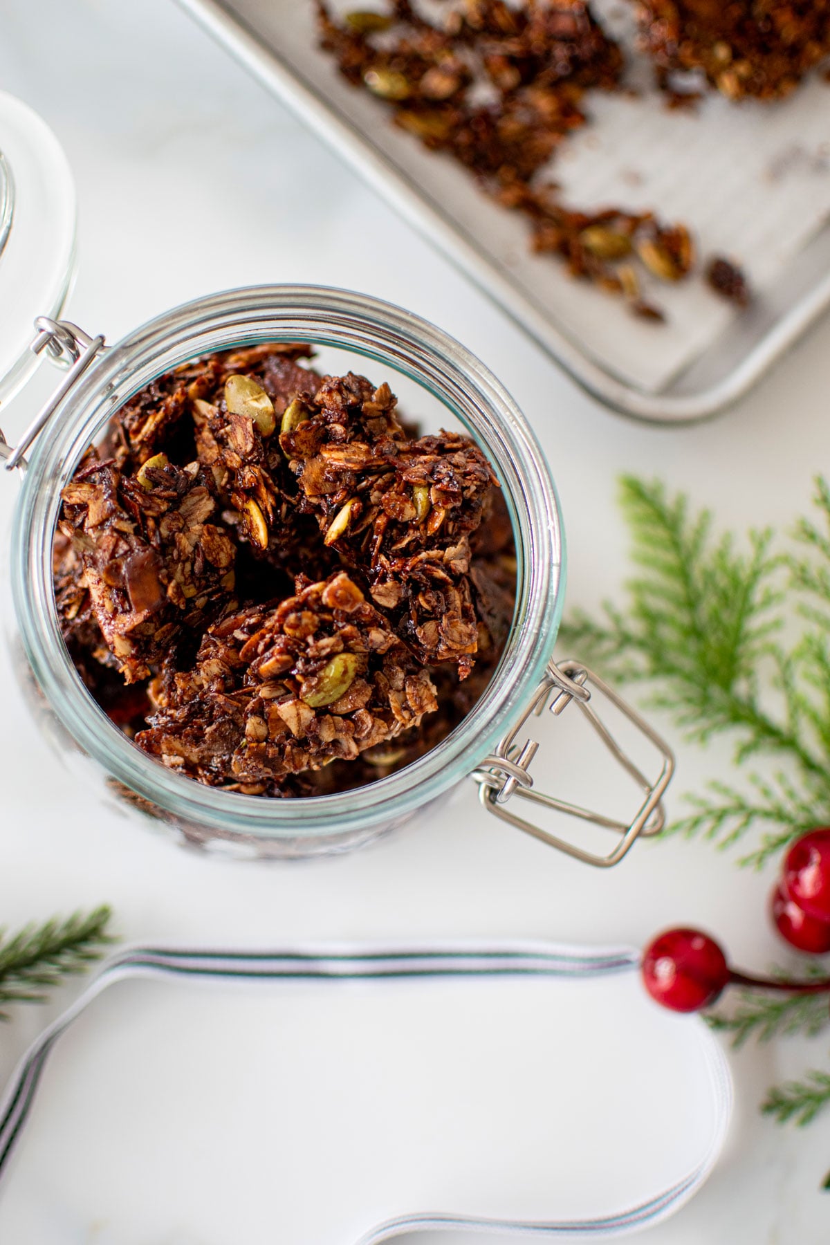 jar of chocolate peppermint olive oil granola on a white marble counte.r