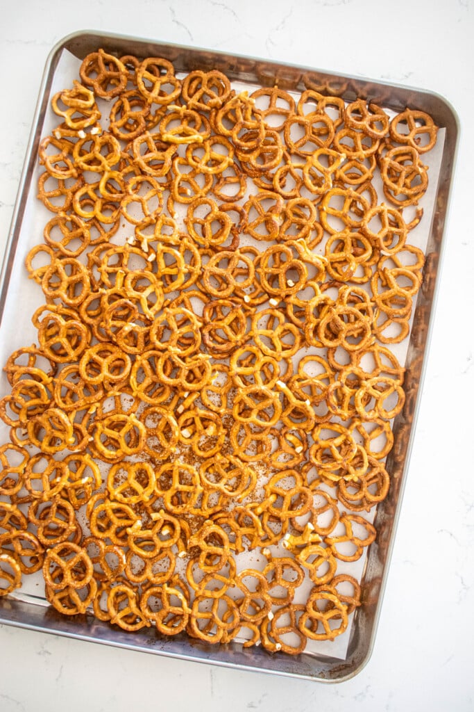 pretzel twists on a baking sheet on a marble counter.