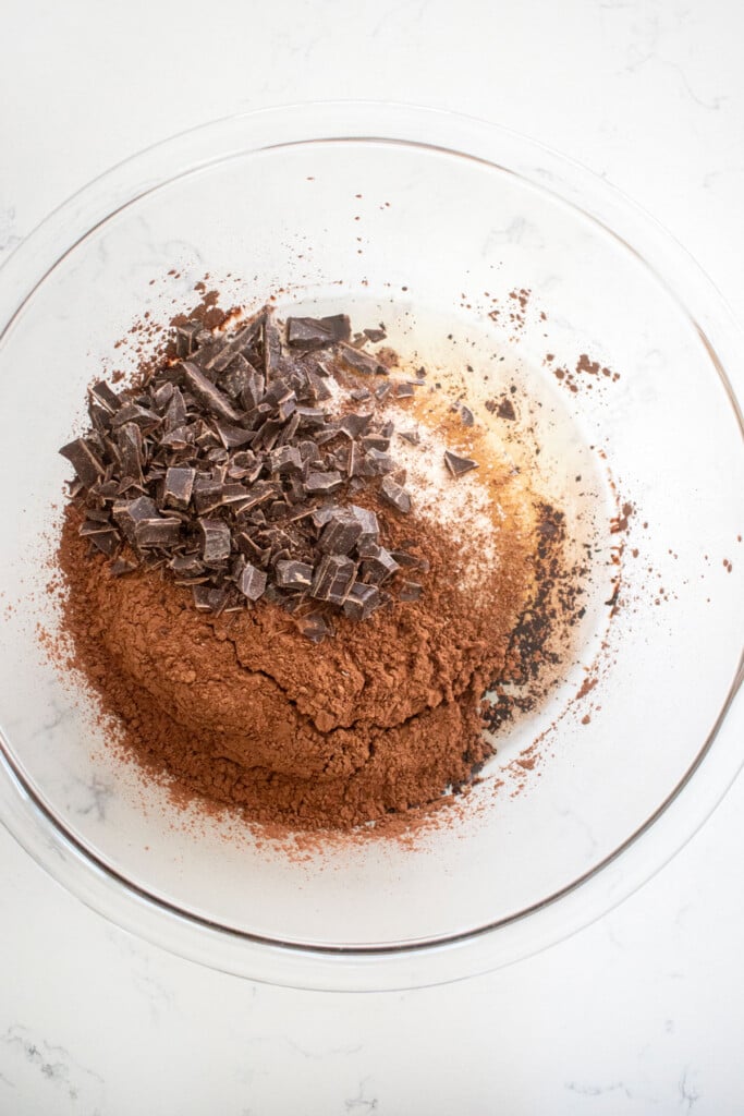ingredients for christmas present brownies in a glass bowl on a marble counter.