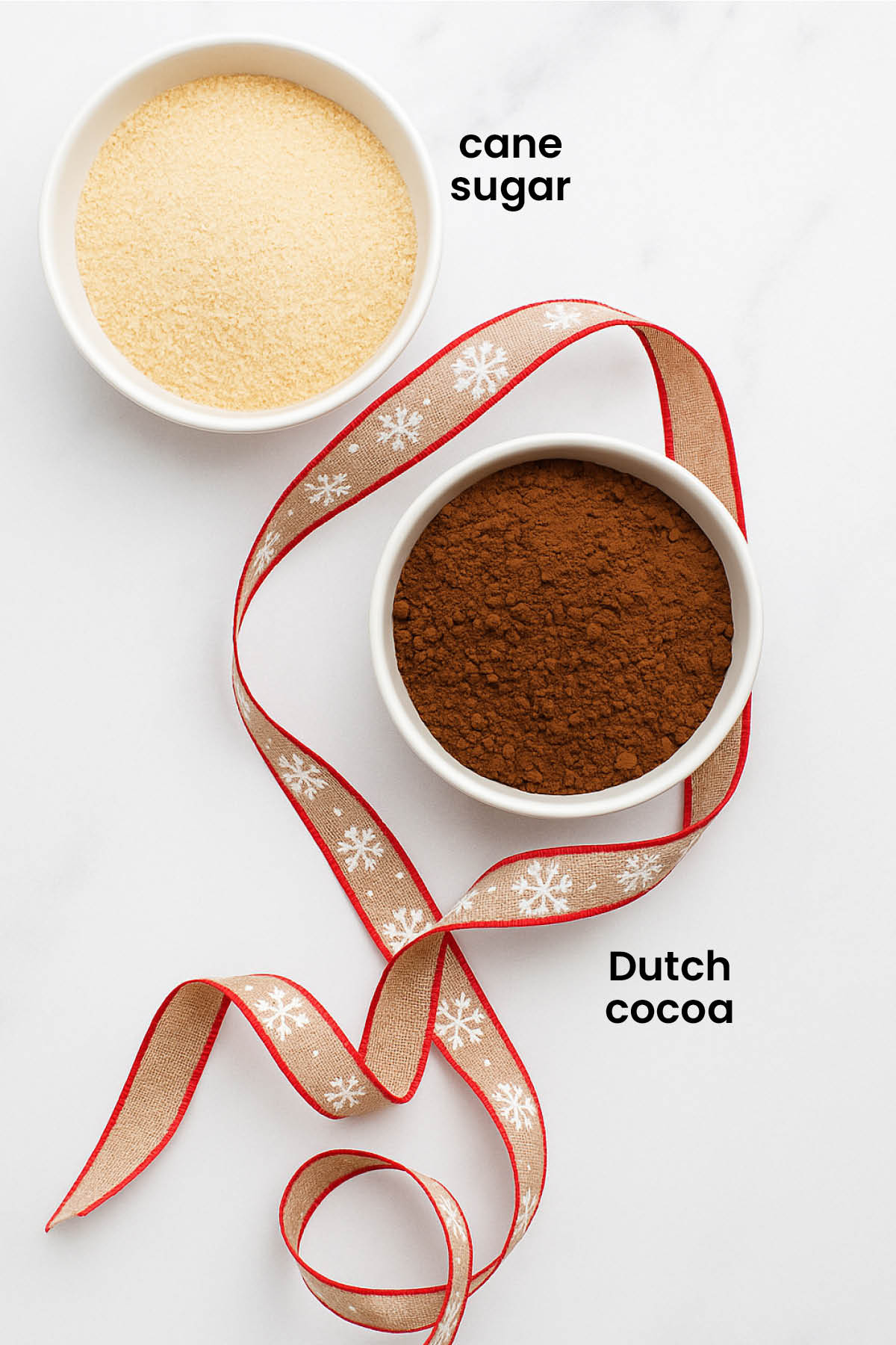 individual ingredients for hot cocoa mix for gifts laid out against a white background.