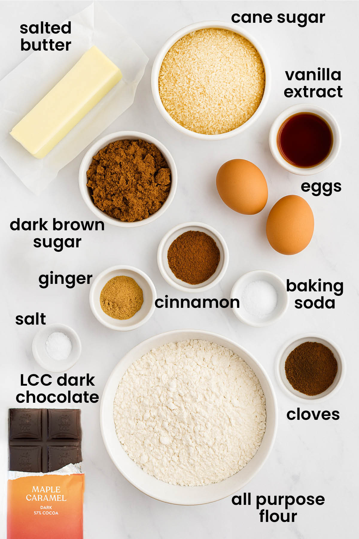 individual ingredients for maple caramel dark chocolate gingerbread bars laid out against a white background.