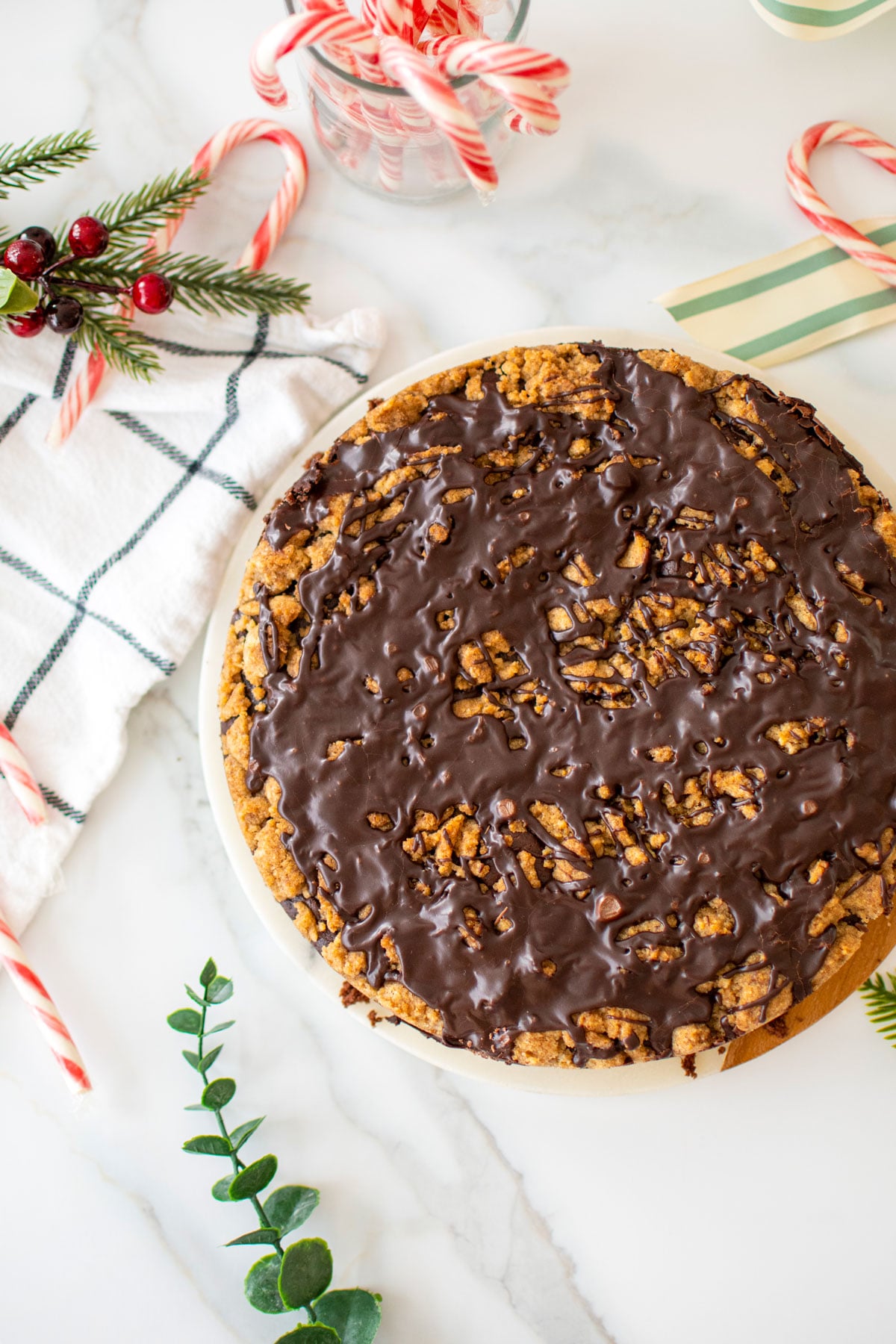 peppermint mocha coffee cake on a marble cake plate on a white marble counter with candy canes.
