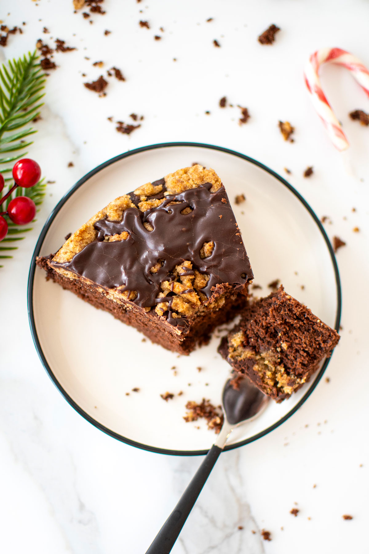 slice of peppermint mocha coffee cake on a cake plate with a bite on a fork on a marble counter.