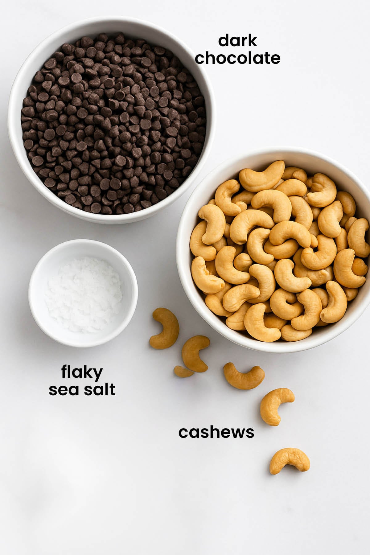 individual ingredients for sea salt dark chocolate cashew clusters laid out against a white background.