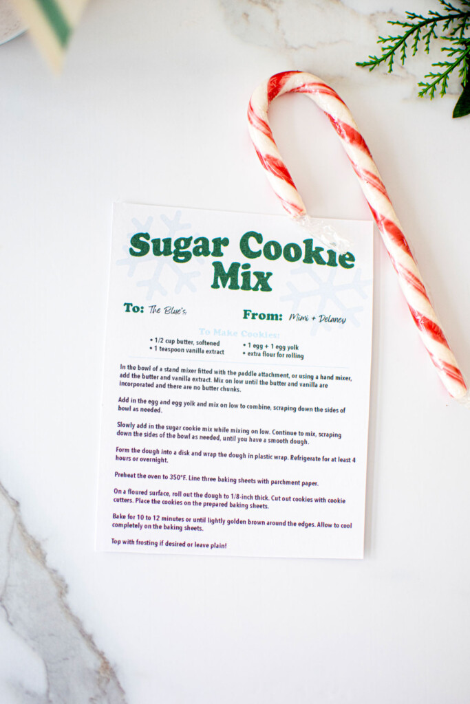 sugar cookie mix recipe card on a marble counter with a candy cane.