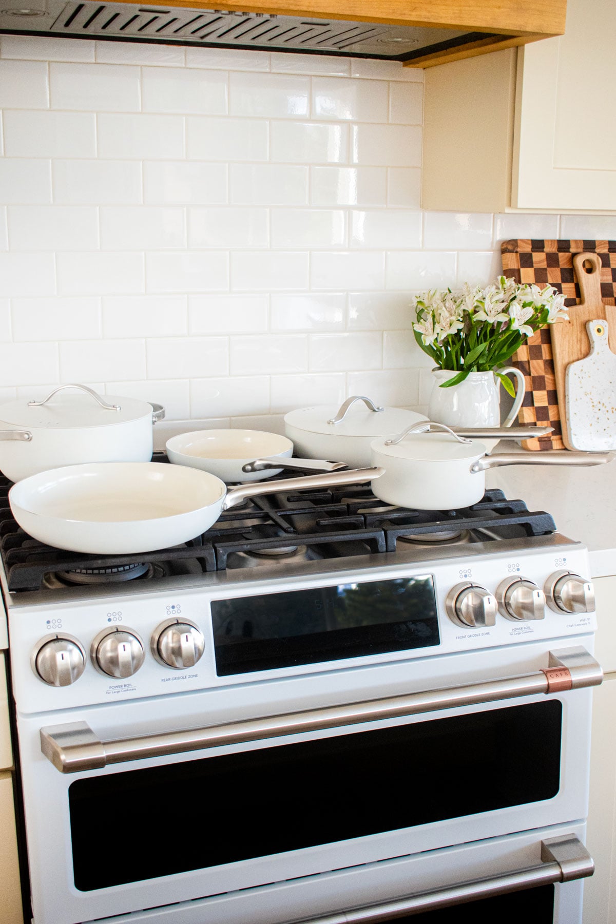 white alva cookware set on top of an oven.