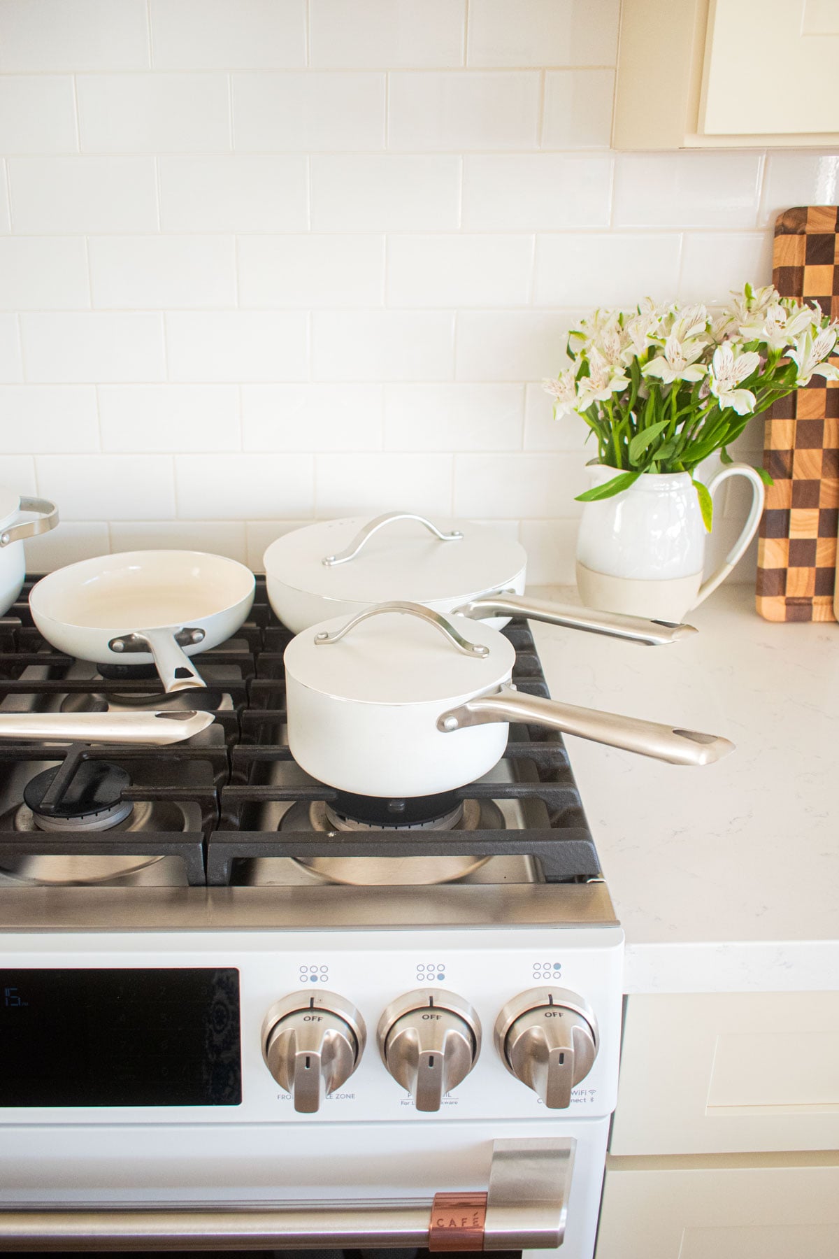 white alva cookware set on top of an oven.