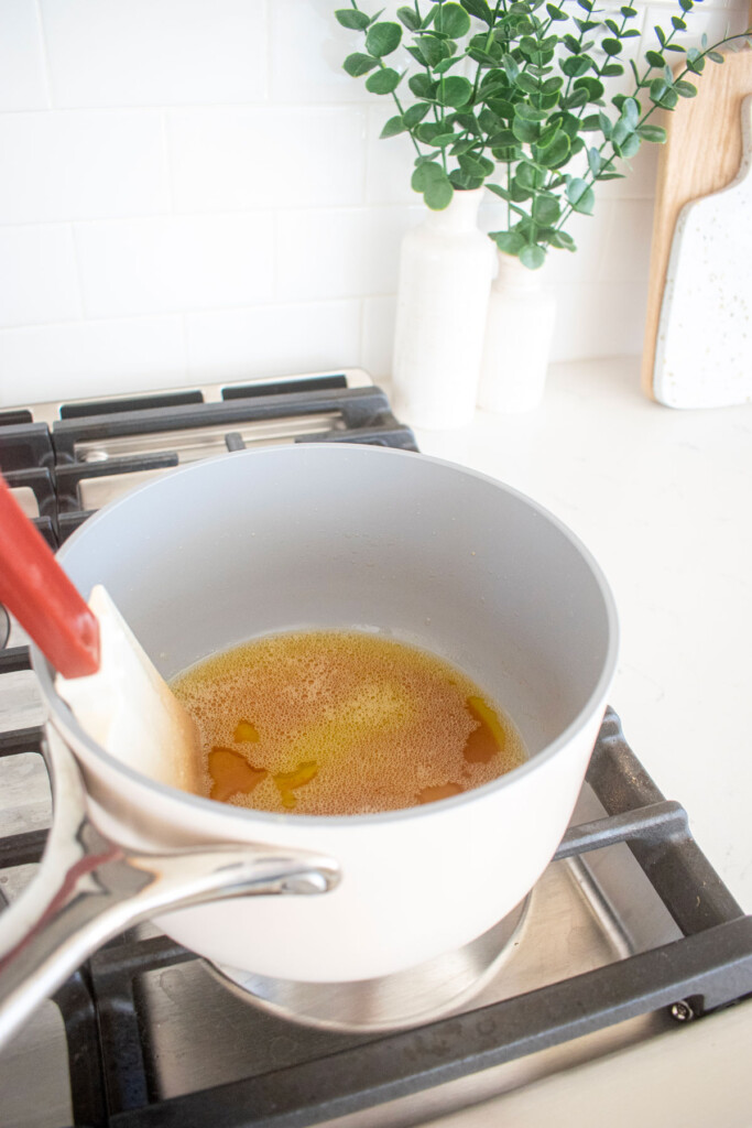 brown butter being made in a small pot on the stovetop.