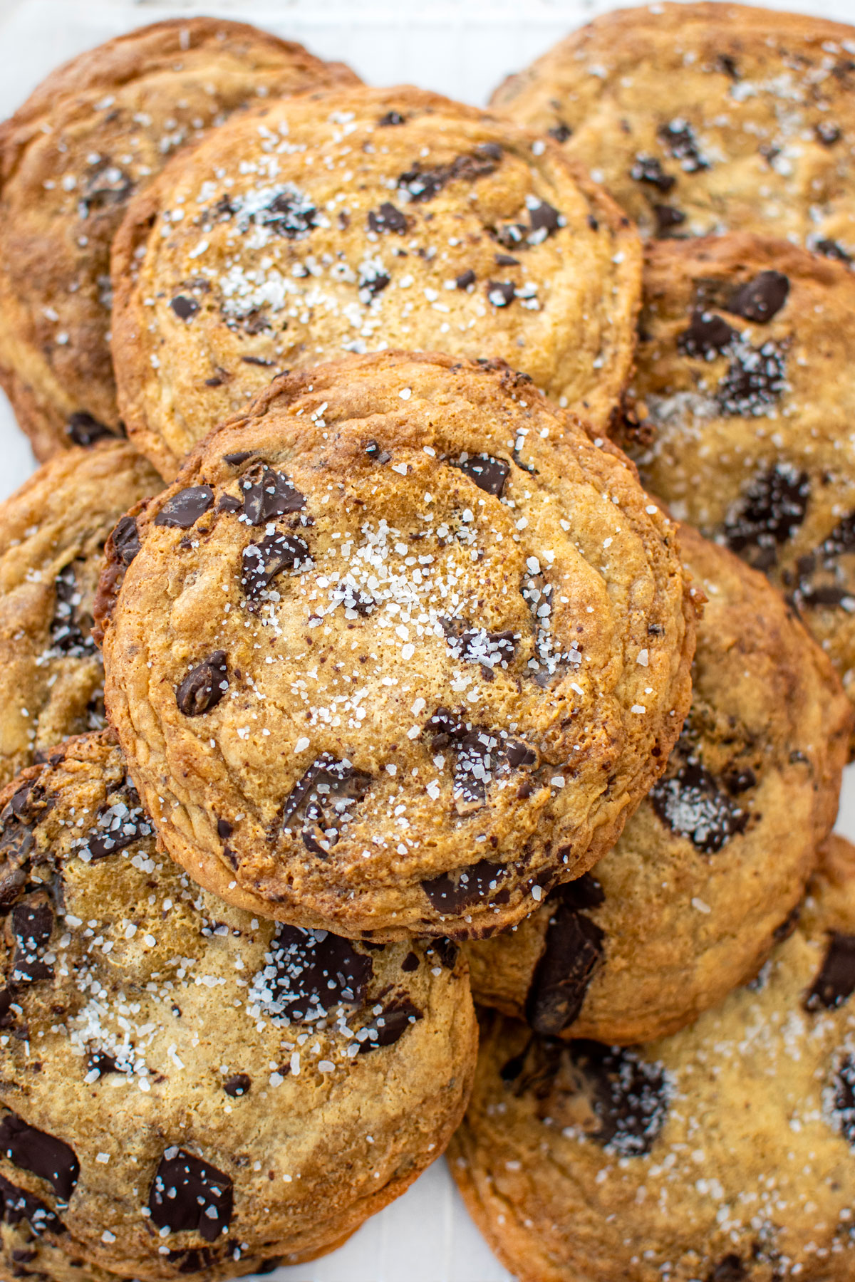brown butter caramel dark chocolate cookies with sea salt on a baking sheet.