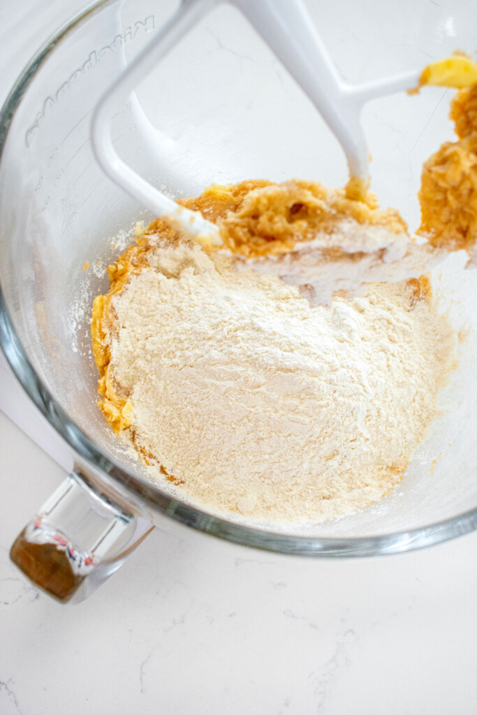 ingredients for brown sugar chocolate chip mini cookies in a glass mixing bowl on a marble counter.