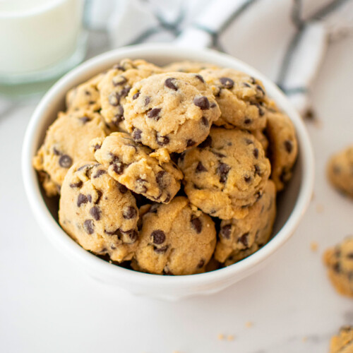 bowl of brown sugar chocolate chip mini cookies on a marble counter.