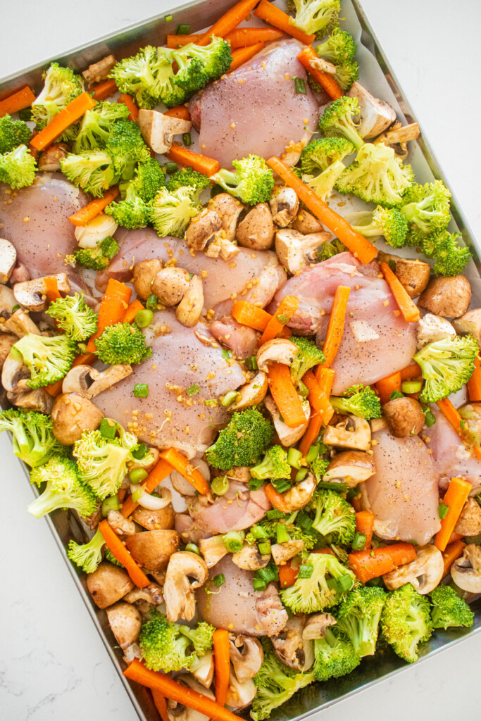 honey garlic sheet pan dinner on a white marble counter.