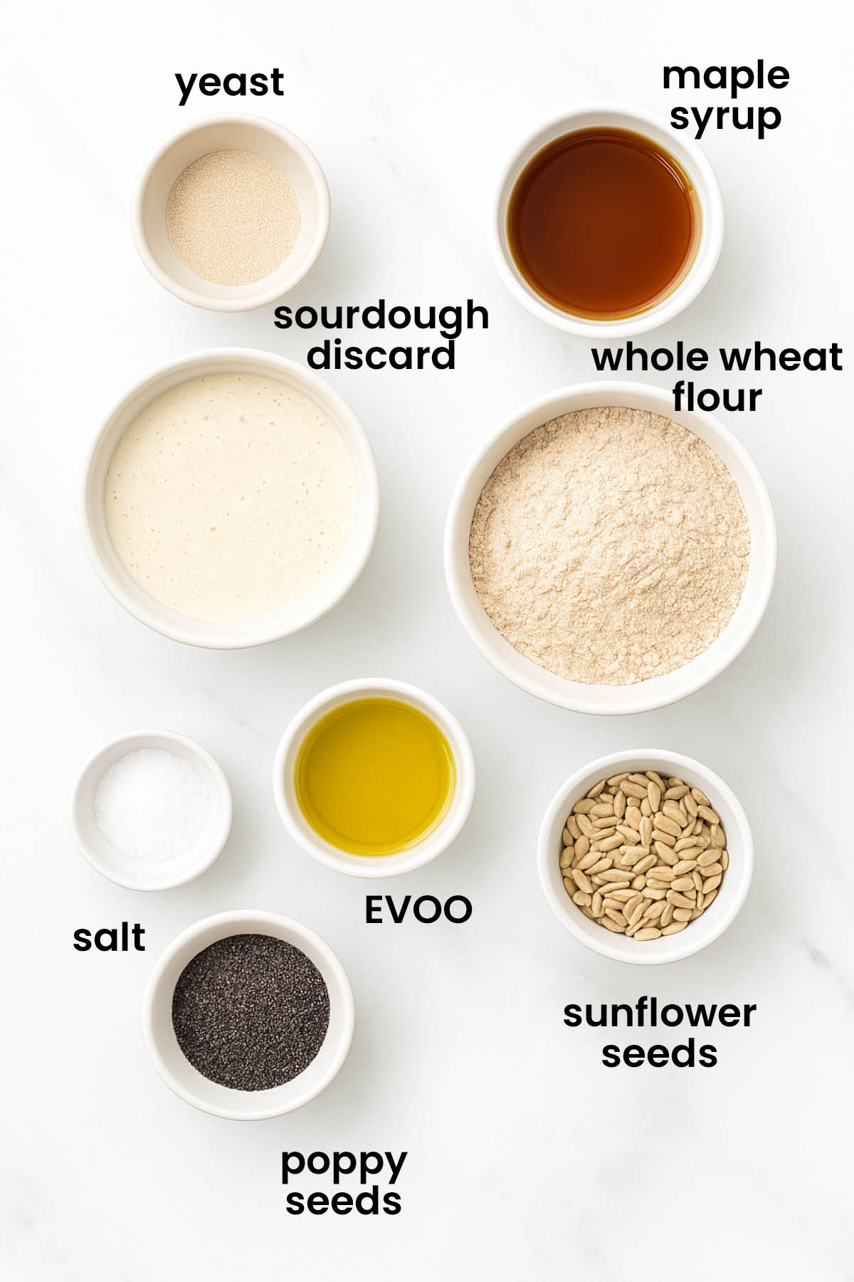 individual ingredients for sourdough discard whole wheat sandwich bread with guinness laid out against a white background.