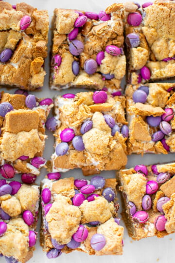 valentine's day smore bars cut into 9 square bars on a white marble counter.