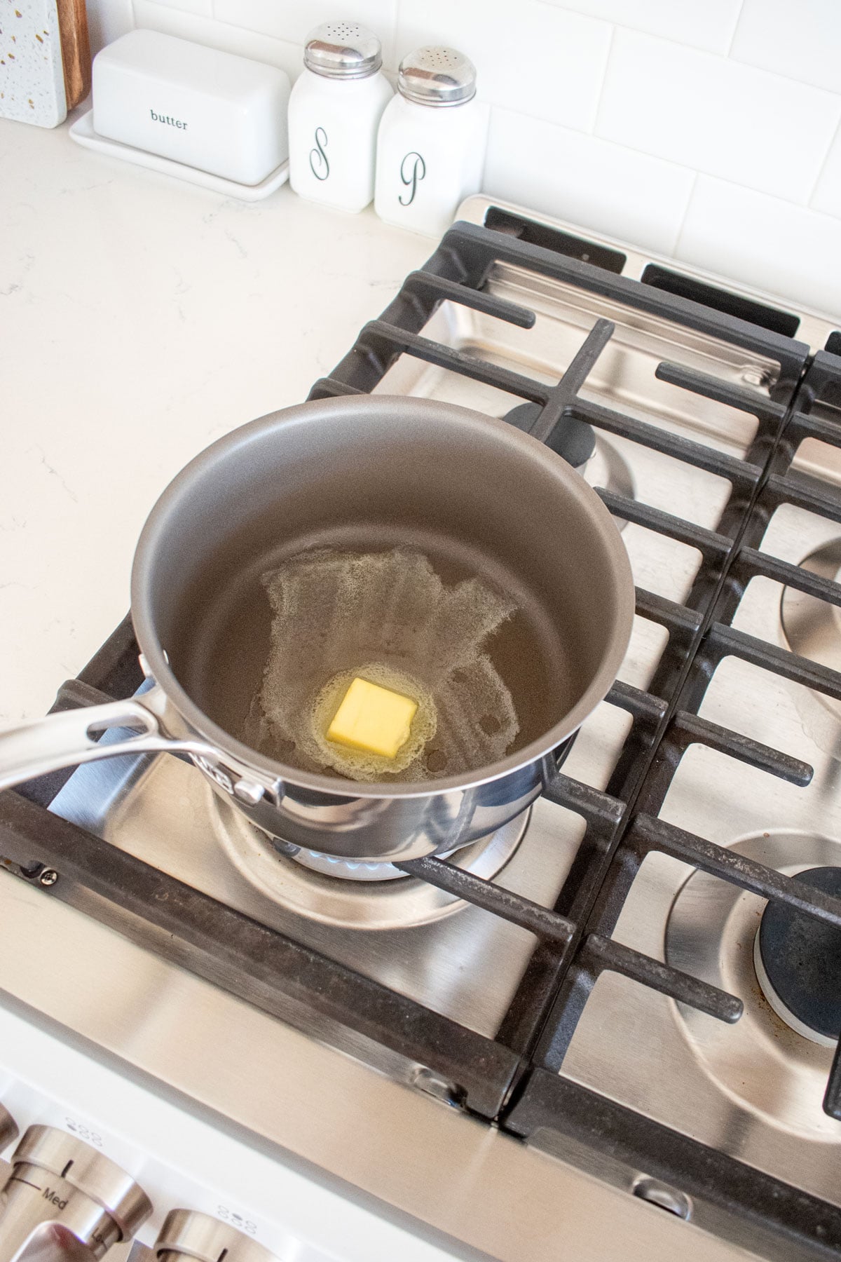 viking pureglide pro saucepan on stovetop with melted butter.