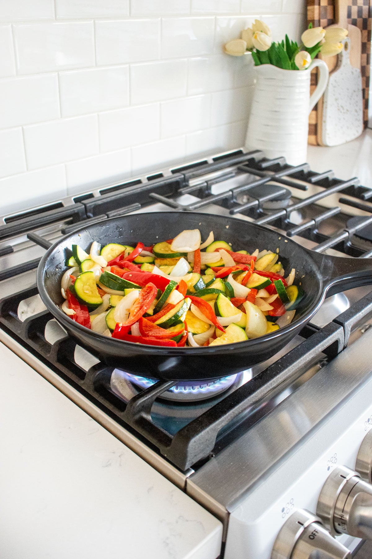 veggies being sauted in an xtrema skillet on the stovetop.