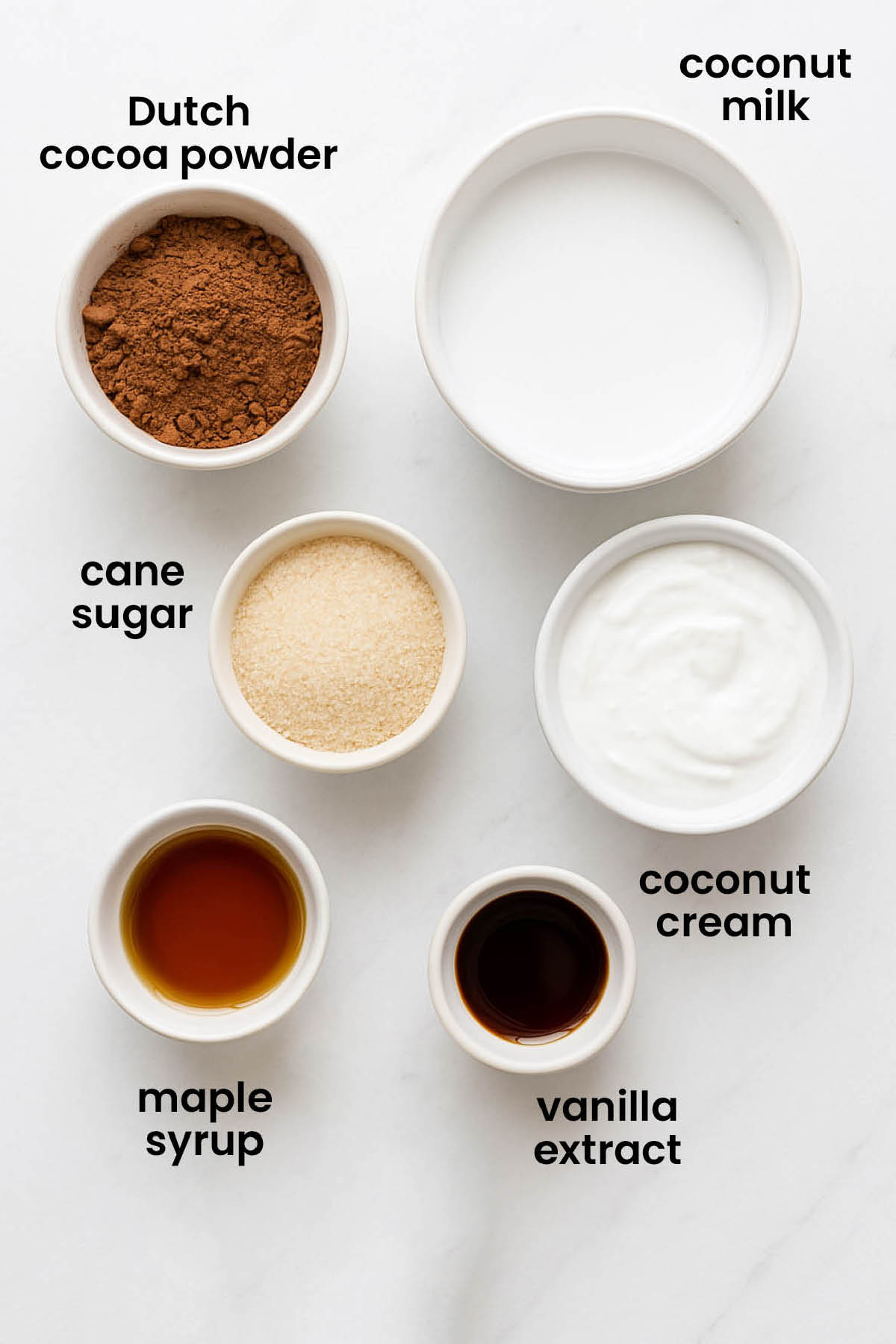 individual ingredients for coconut hot chocolate laid out against a white background.