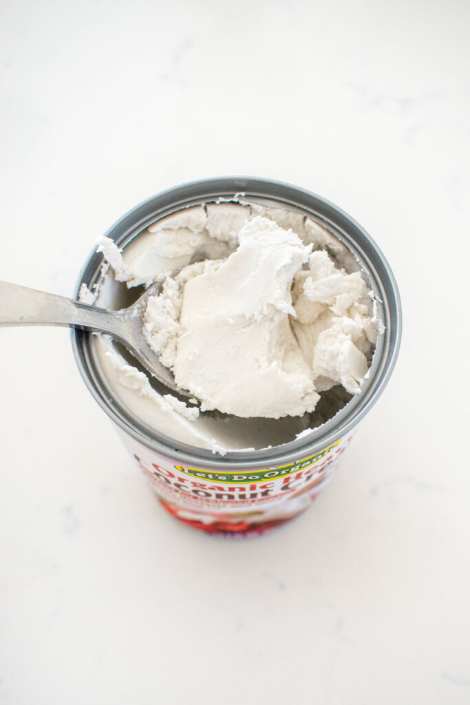 can of coconut cream on a white marble counter.