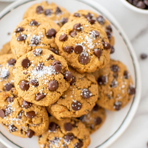 plate of healthy chocolate chip cookies with coconut sugar on a white marble counter.