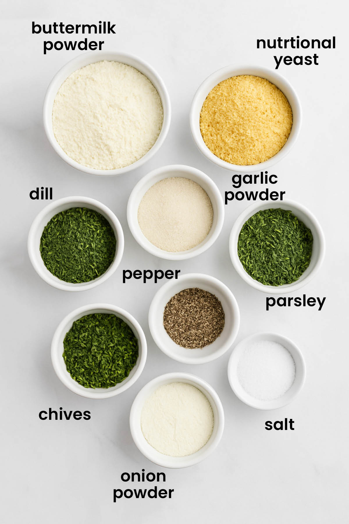 individual ingredients for homemade ranch seasoning mix with no sugar laid out against a white background.