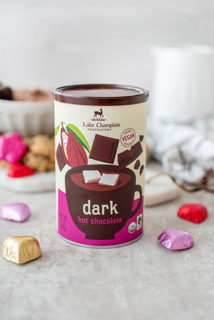 lake champlain dark hot chocolate mix on a table with chocolate hearts.