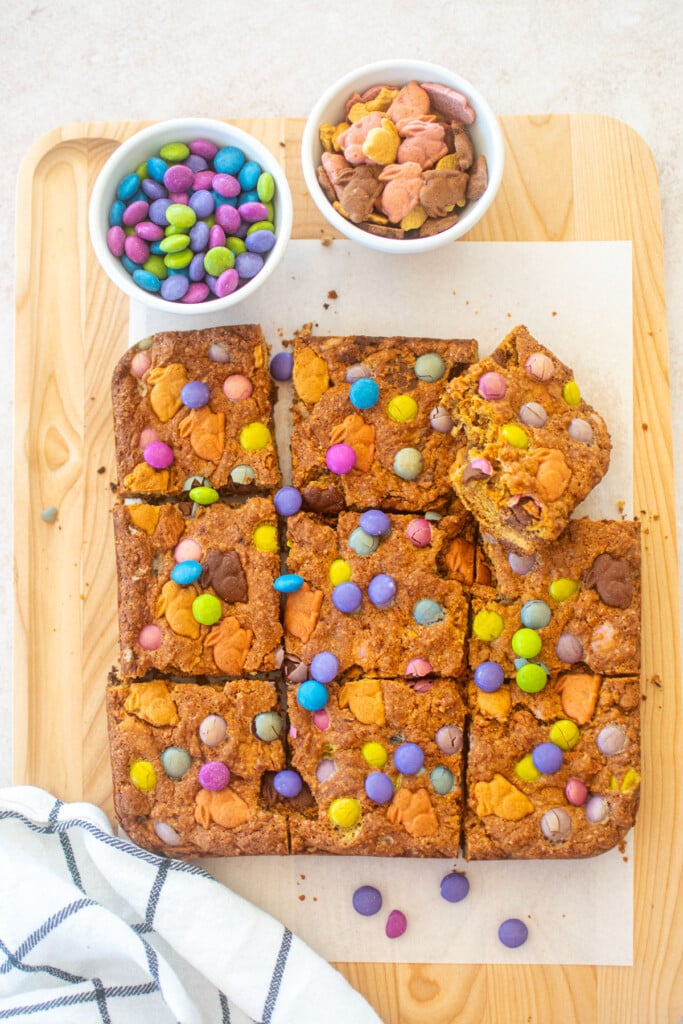 easter banana blondies cut into squares on a wood cutting board.