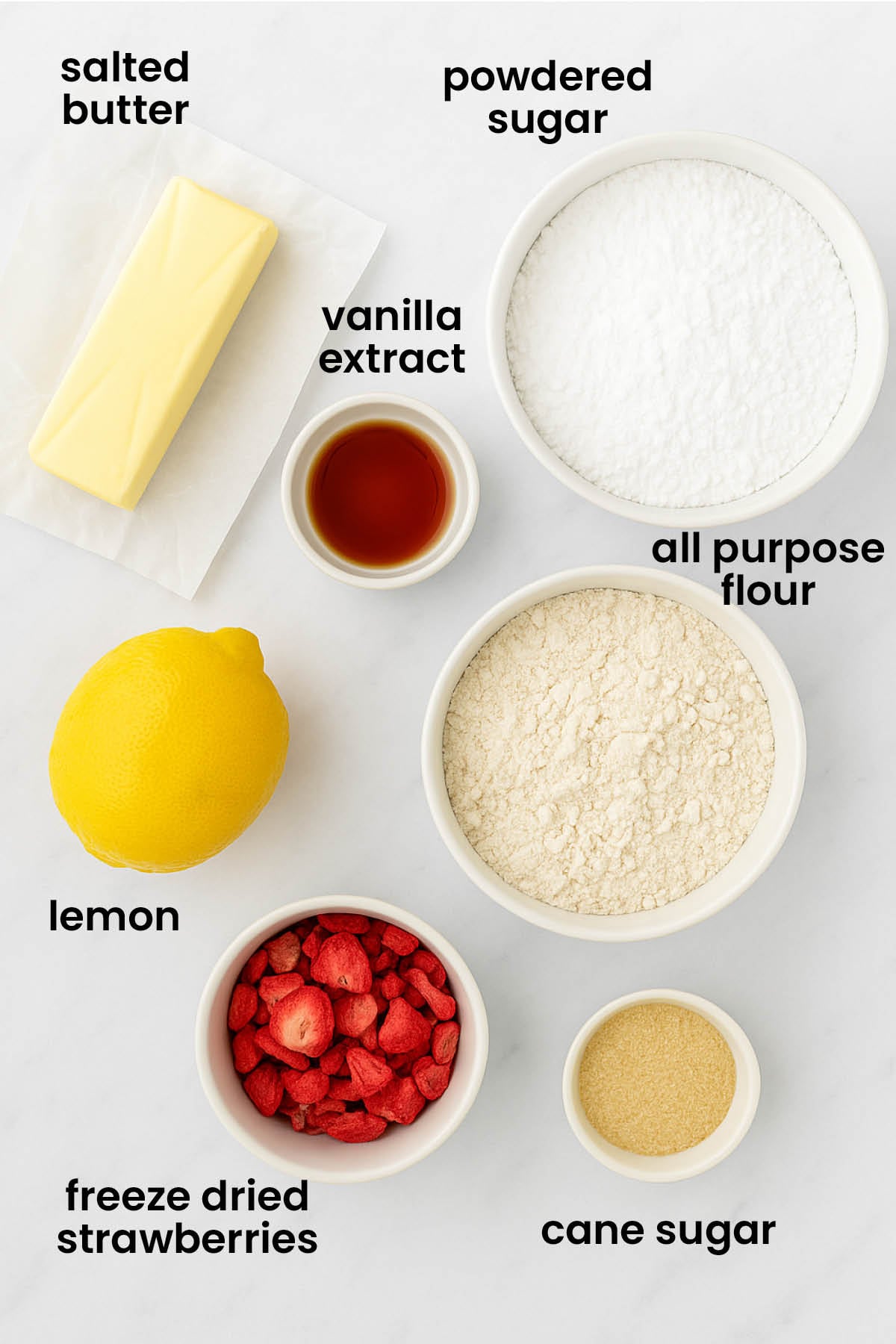 individual ingredients for strawberry lemonade sandwich cookies laid out against a white background.