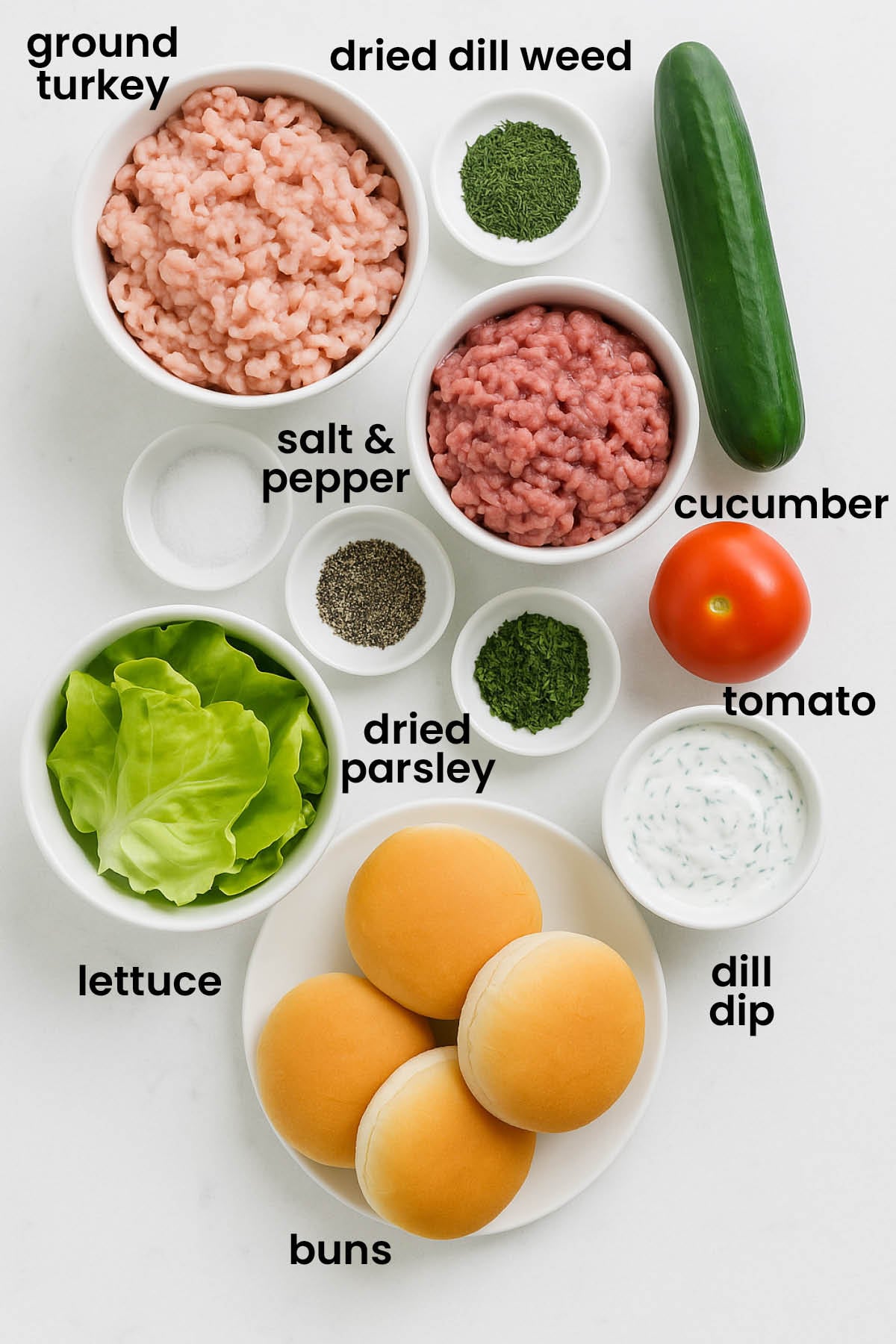 individual ingredients for turkey and lamb burgers with dill sauce laid out against a white background.