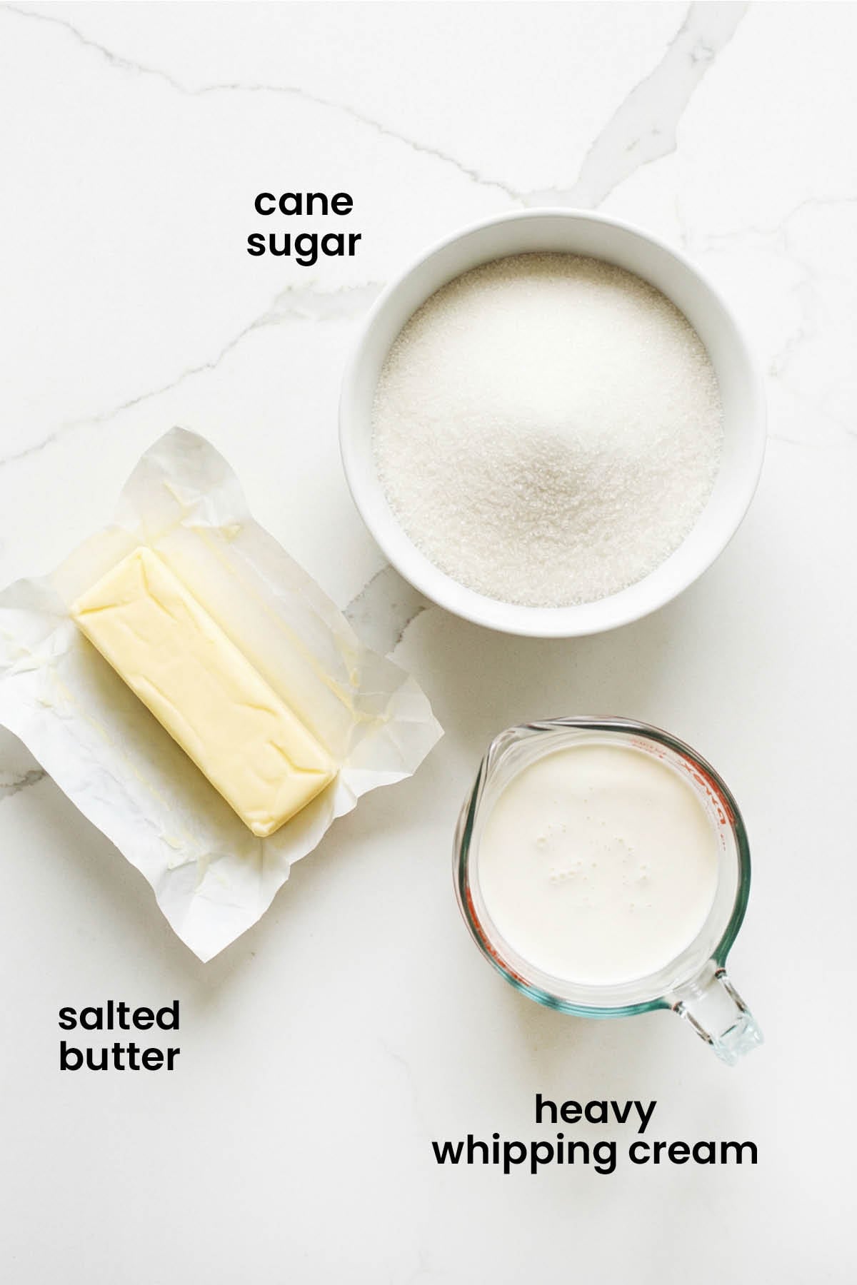 individual ingredients for homemade true caramel laid out against a white background.