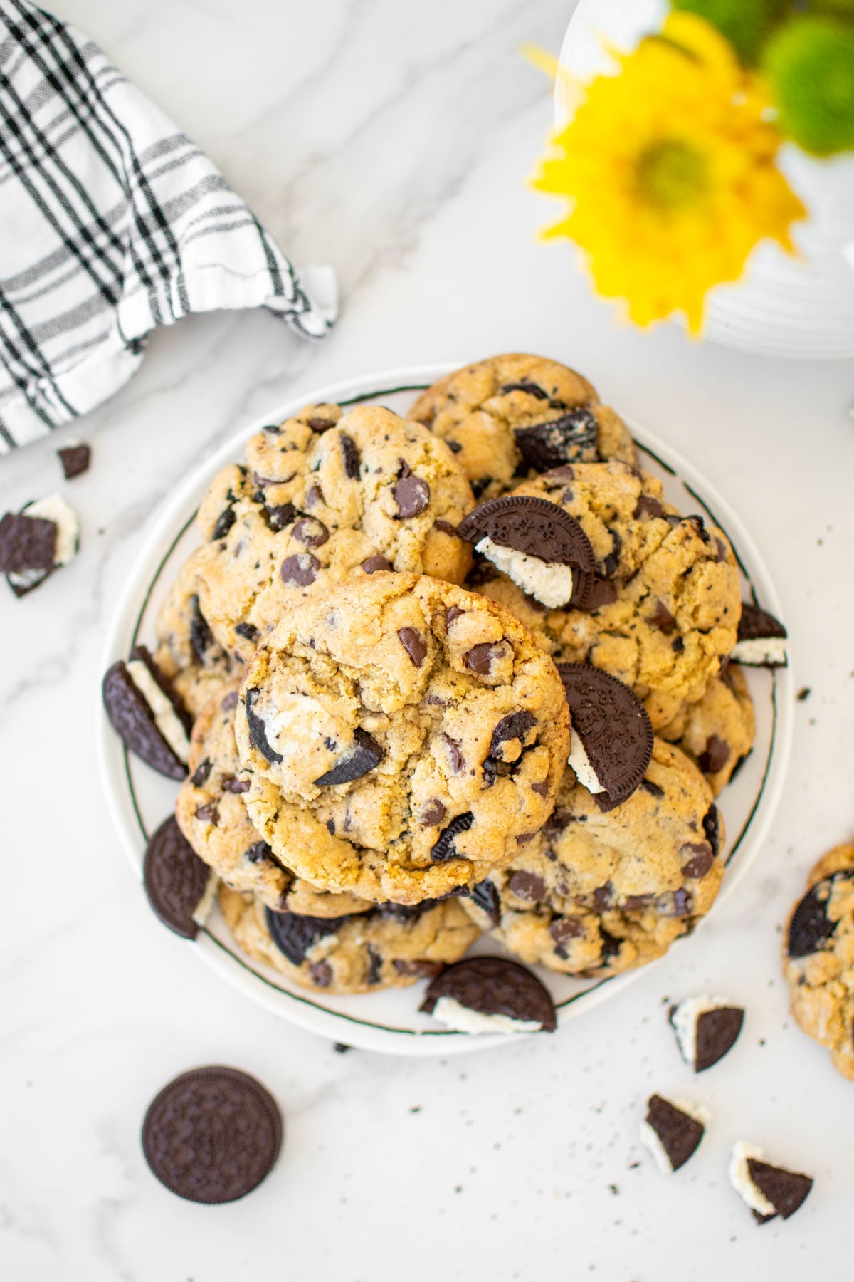 vegan oreo chocolate chip cookies on a plate on a white marble counter.