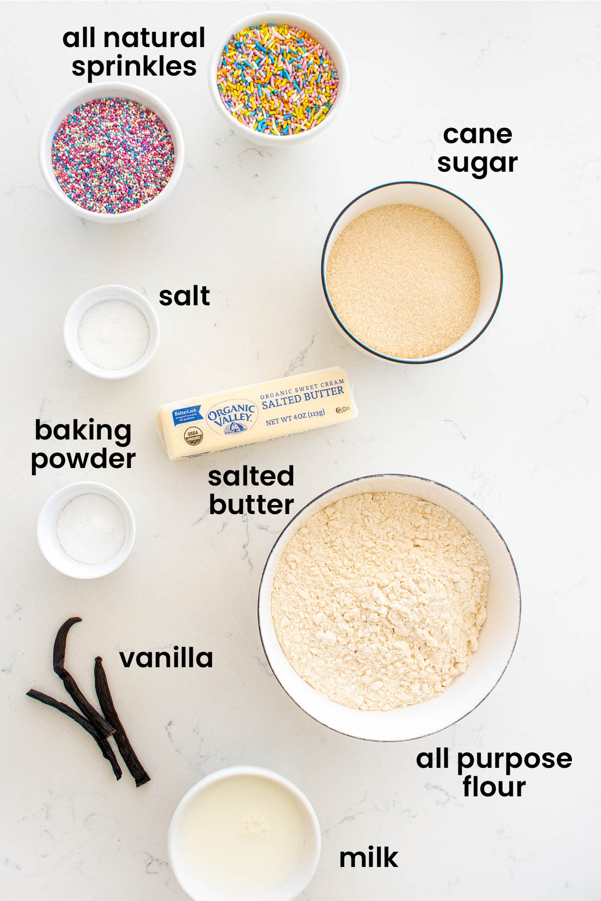 individual ingredients for eggless sprinkle cookies laid out against a white background.