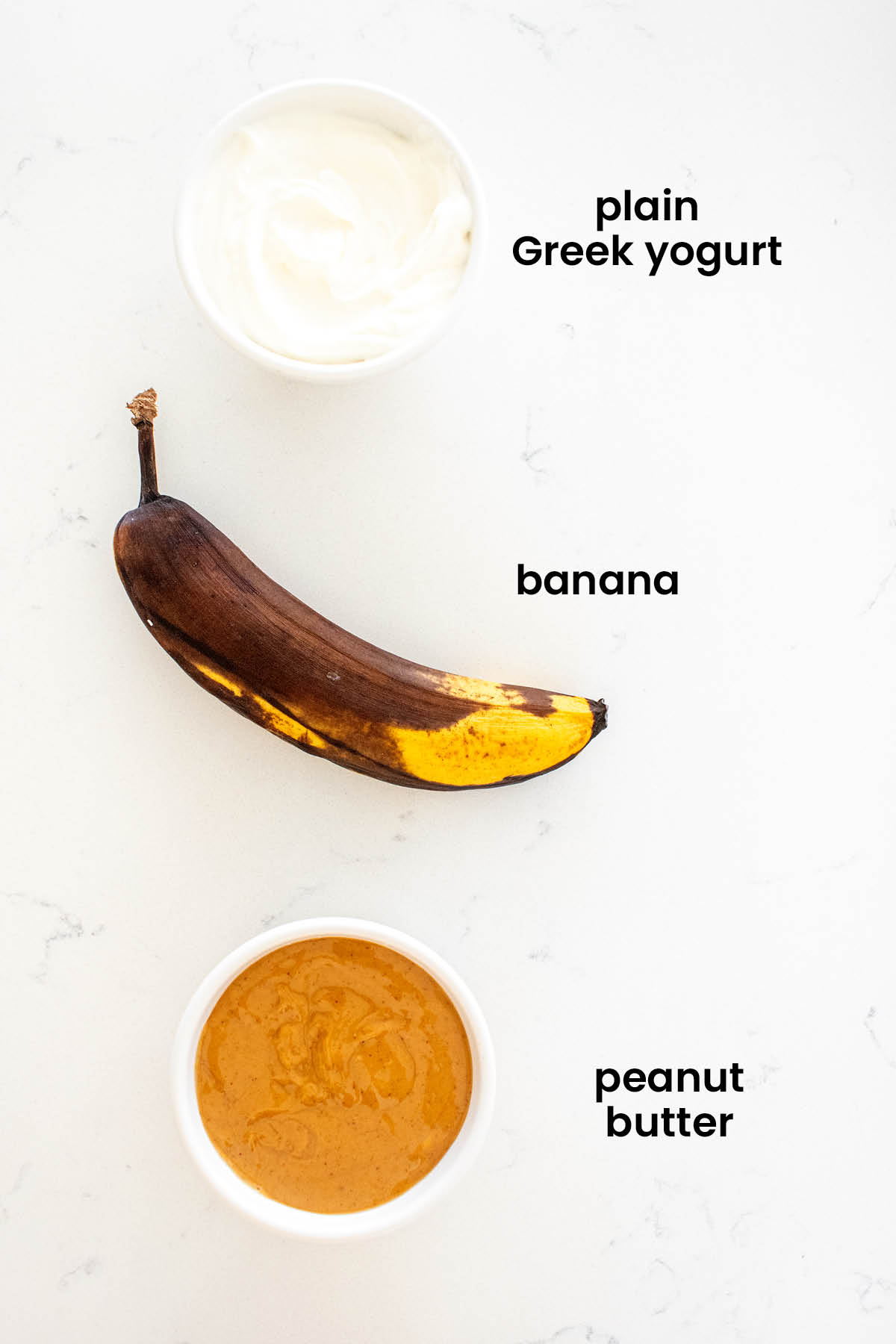 individual ingredients for frozen peanut butter dog treats laid out against a white background.