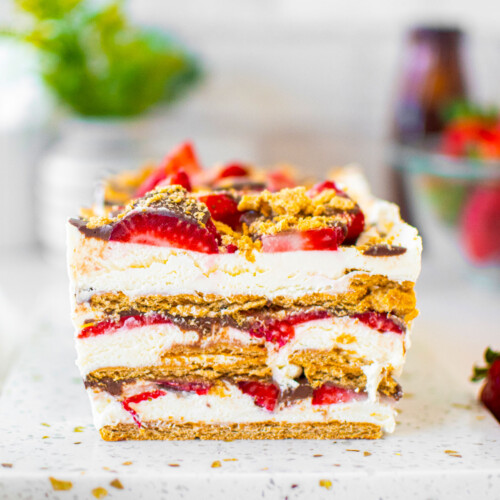 neapolitan icebox cake on a white marble serving board on a white marble table.