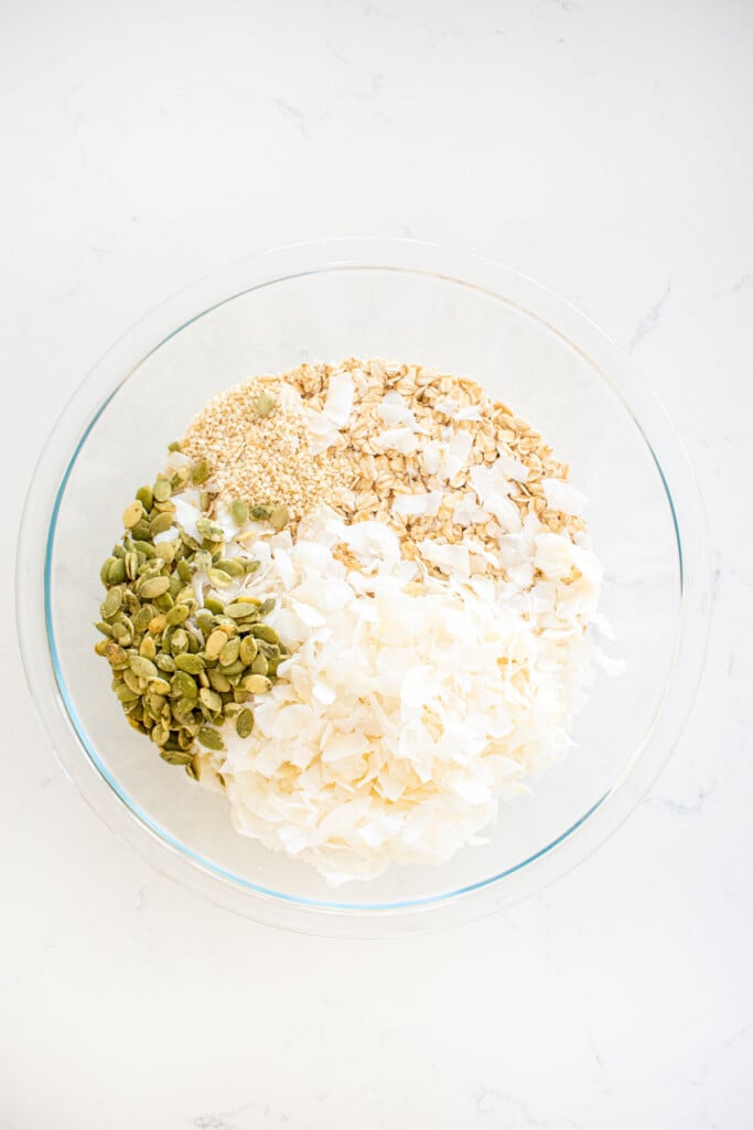pumpkin granola for dogs dry ingredients mixed into a bowl.