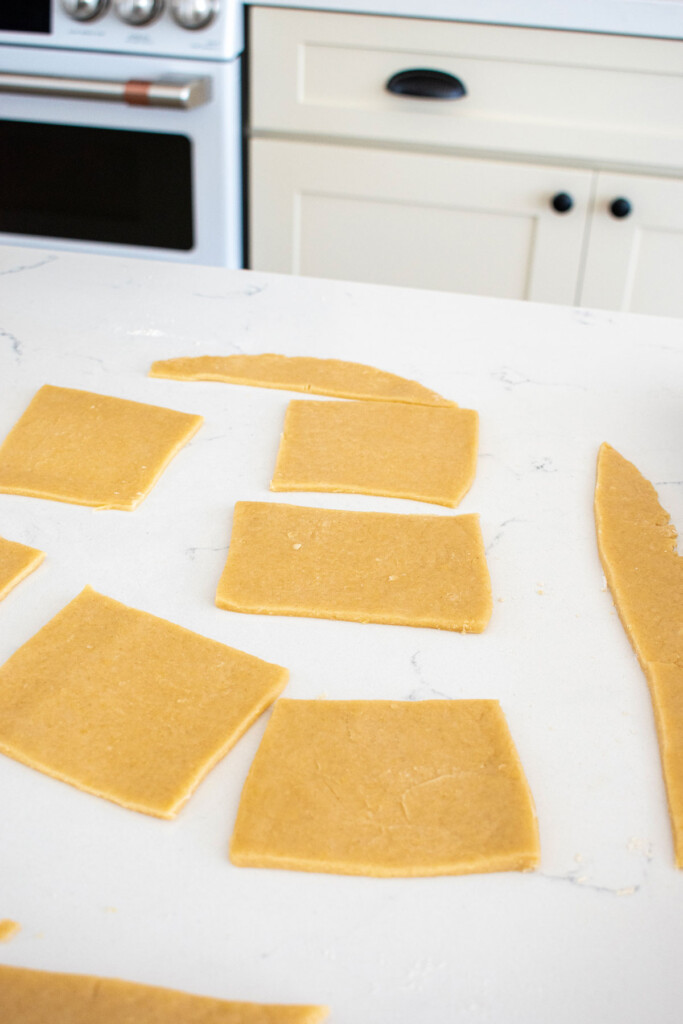 sourdough pop tart dough squares on a white marble countertop.