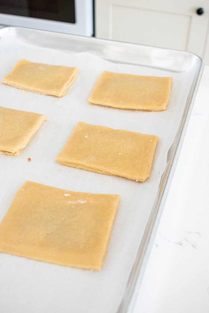 unbaked sourdough strawberry pop tarts on a baking sheet.