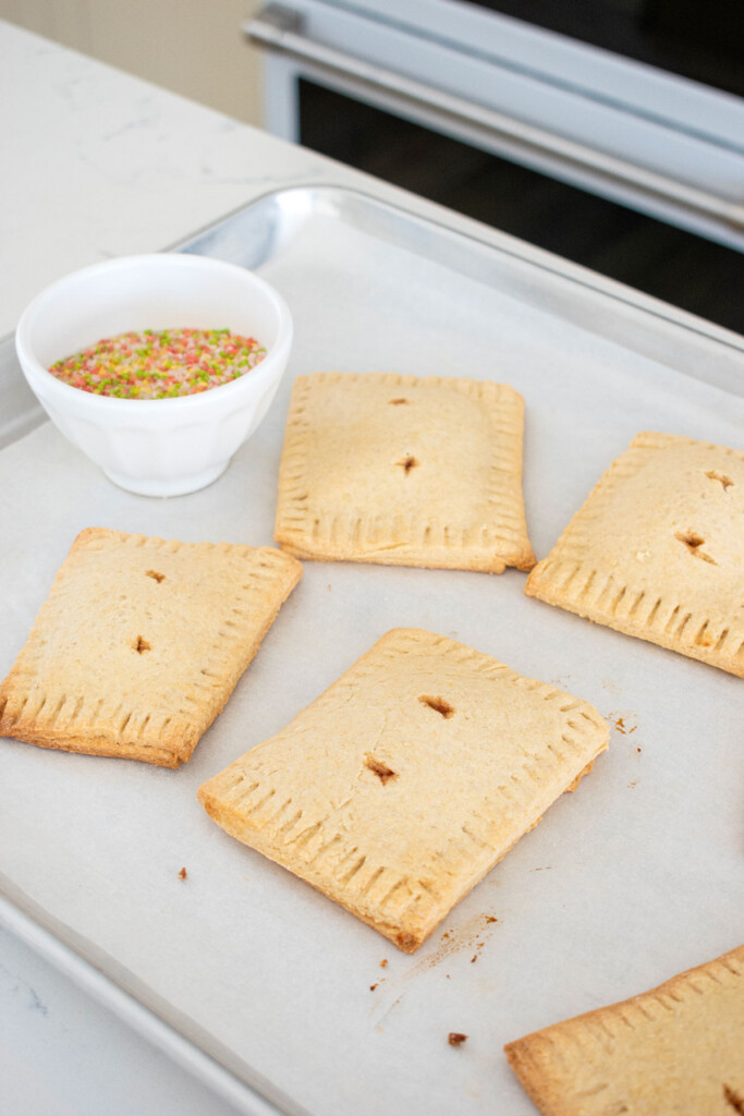 baked sourdough strawberry pop tarts on a baking sheet.