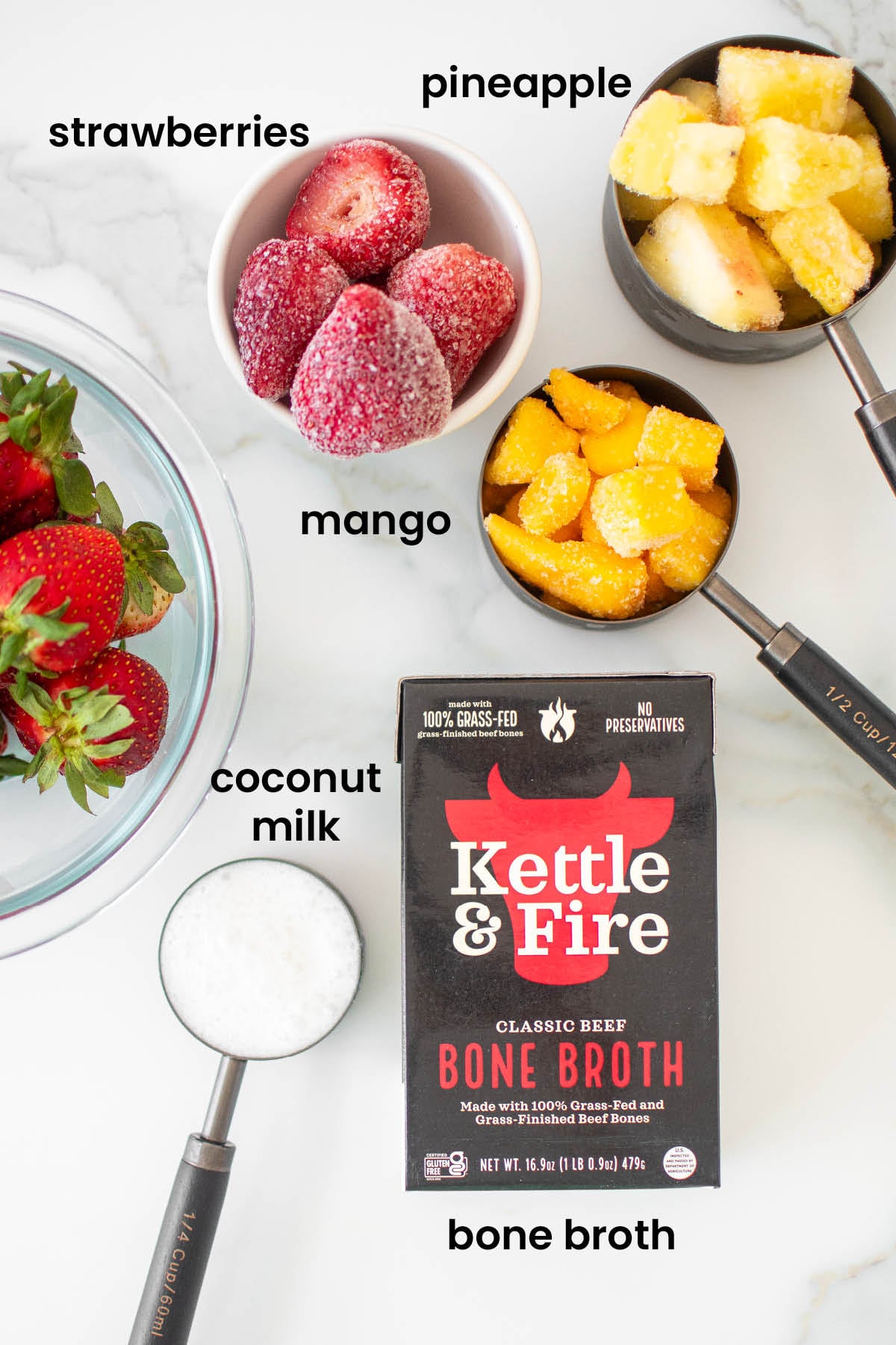 individual ingredients for tropical bone broth smoothie laid out against a white background.