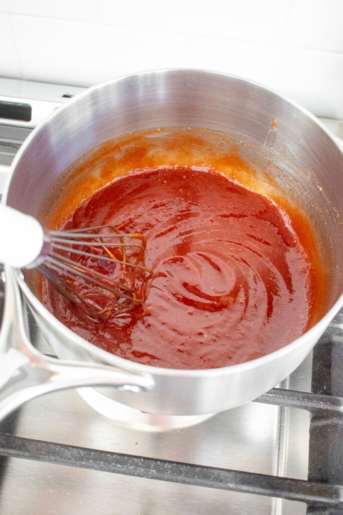 homemade bbq sauce with bone broth in a pot on the stovetop.