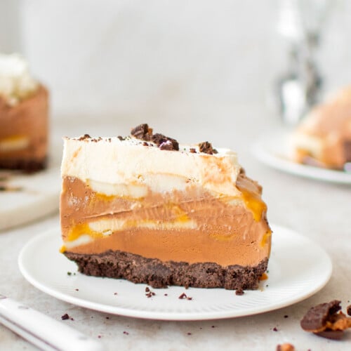 chocolate banana caramel ice cream pie slice on a plate on a table.