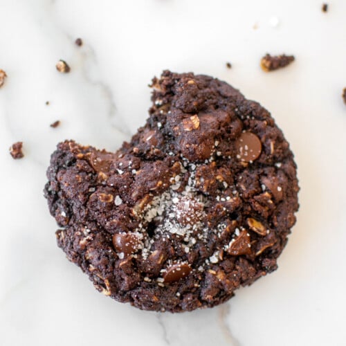 eggless chocolate oatmeal raisin cookie on a marble counter.