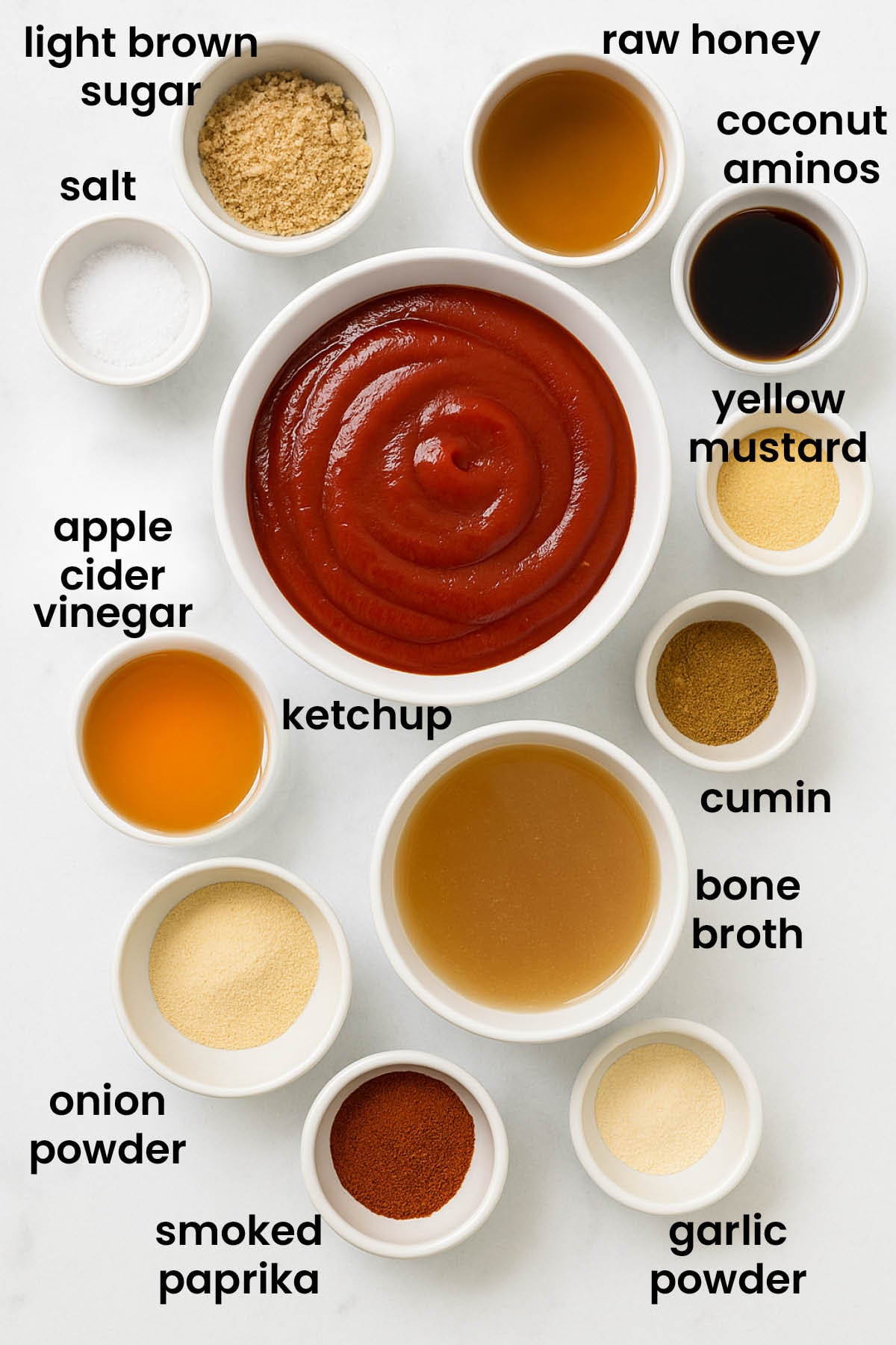 individual ingredients for homemade bbq sauce with bone broth laid out against a white background.