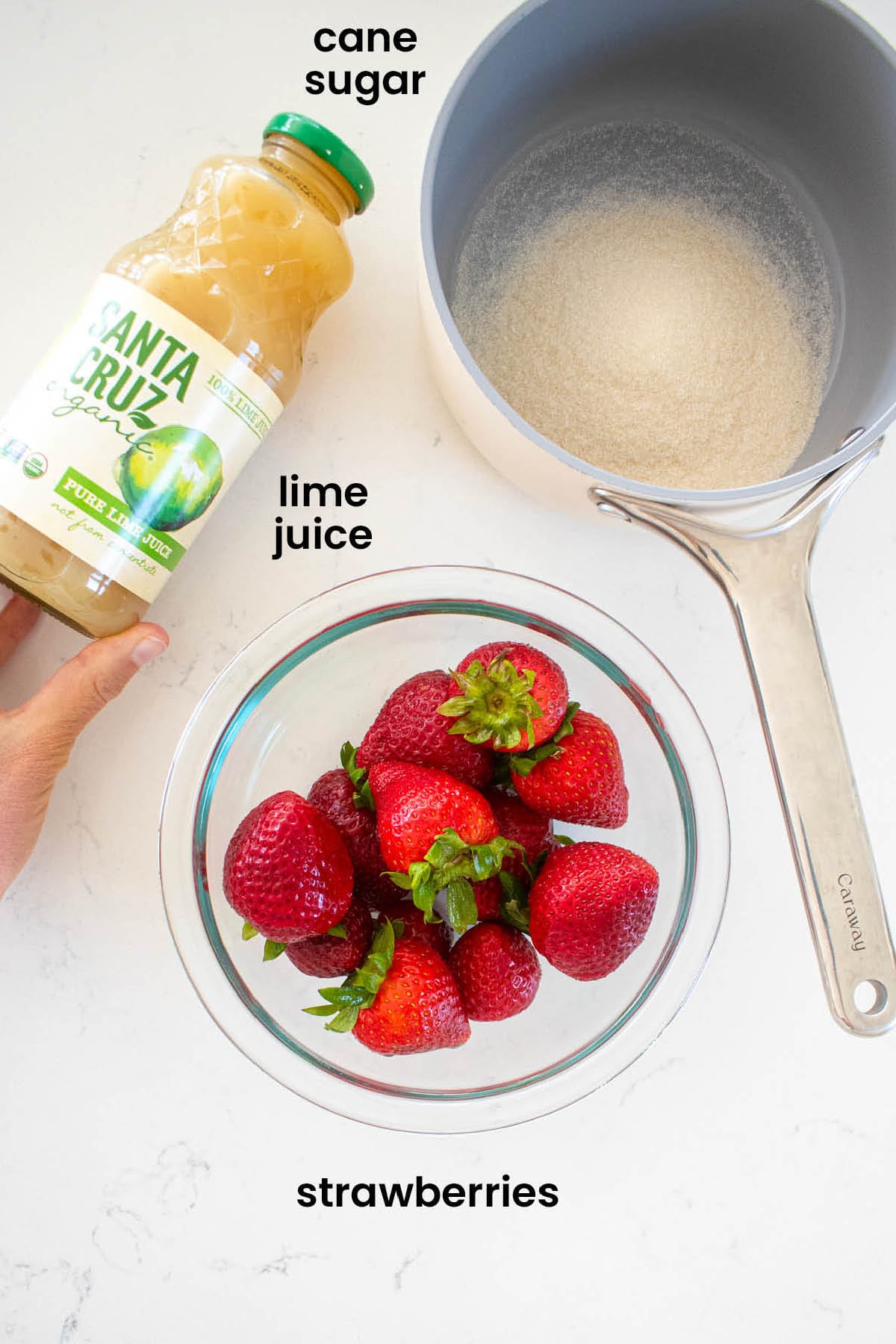 individual ingredients for strawberry limeade laid out against a white background.