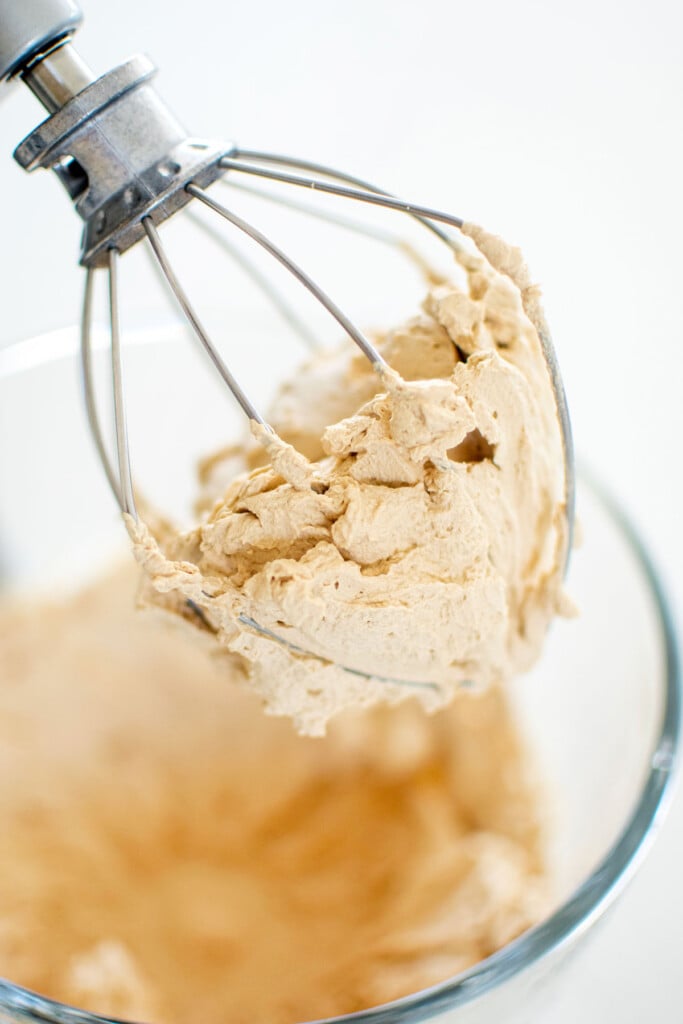 whipped cream and espresso whipped to stiff peaks in a glass stand mixing bowl.