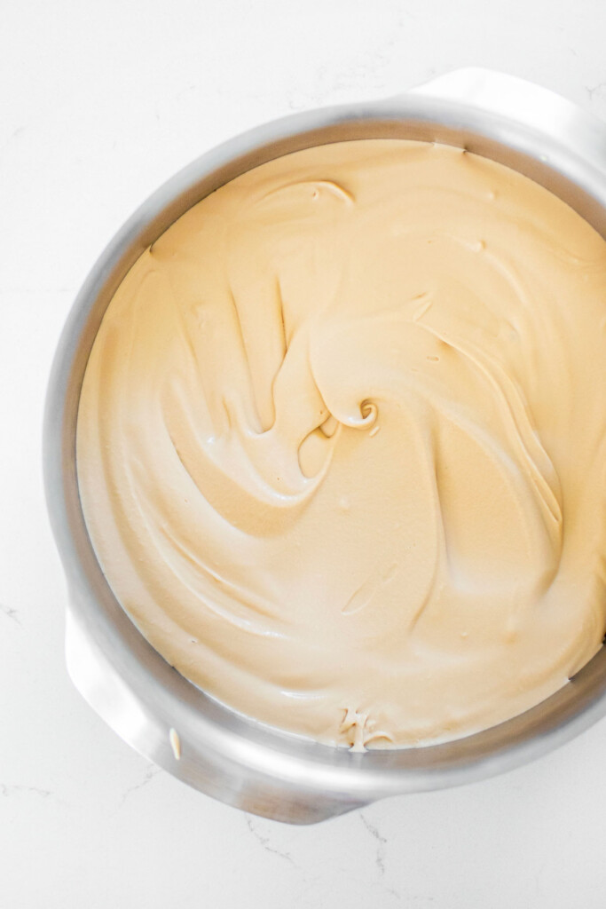 no churn coffee ice cream in a cake pan on a white marble counter.