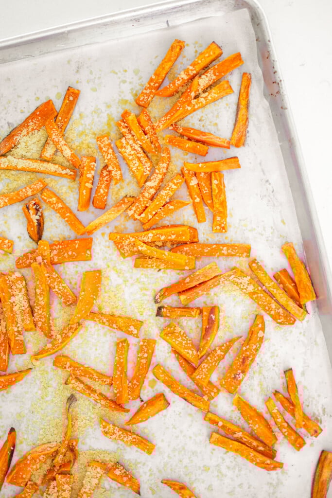 dog friendly sweet potato fries on a baking sheet on a white marble countertop.