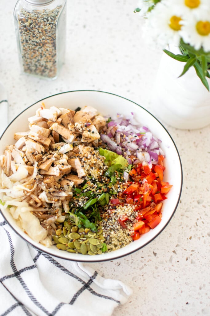 gut healthy chicken salad in a large bowl on a white countertop.