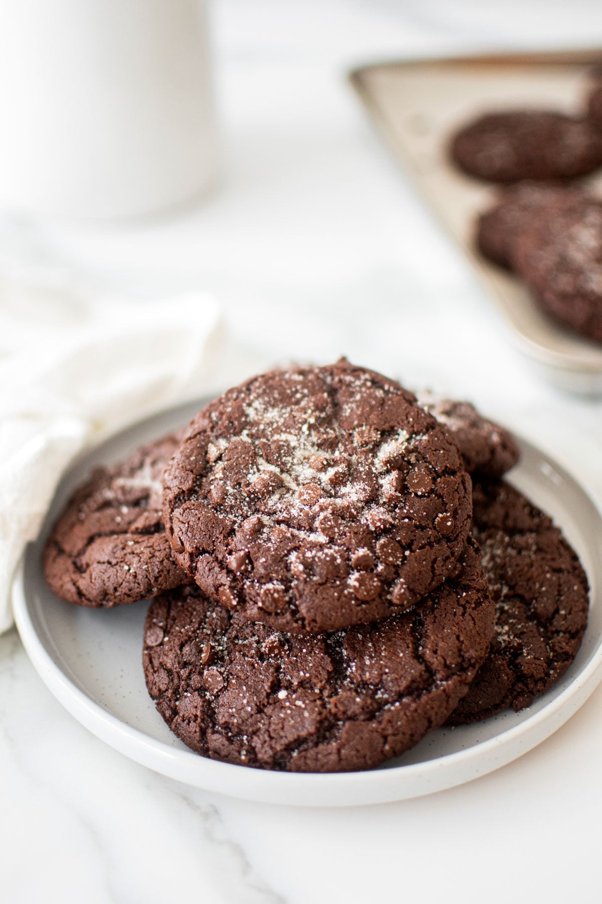plate of chewy chocolate espresso cookies on a white marble counter.