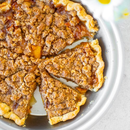 peach crumble pie in a stainless steel pan.