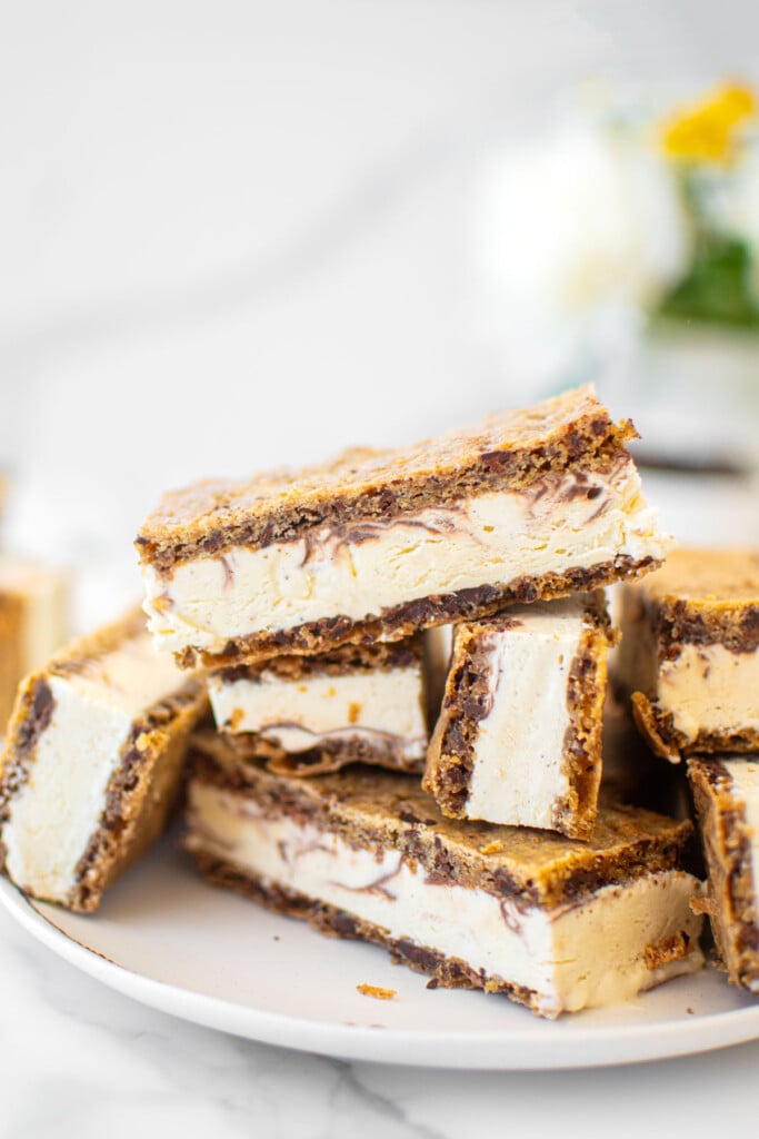 plate of sourdough chocolate chip ice cream sandwiches on a white marble counter.